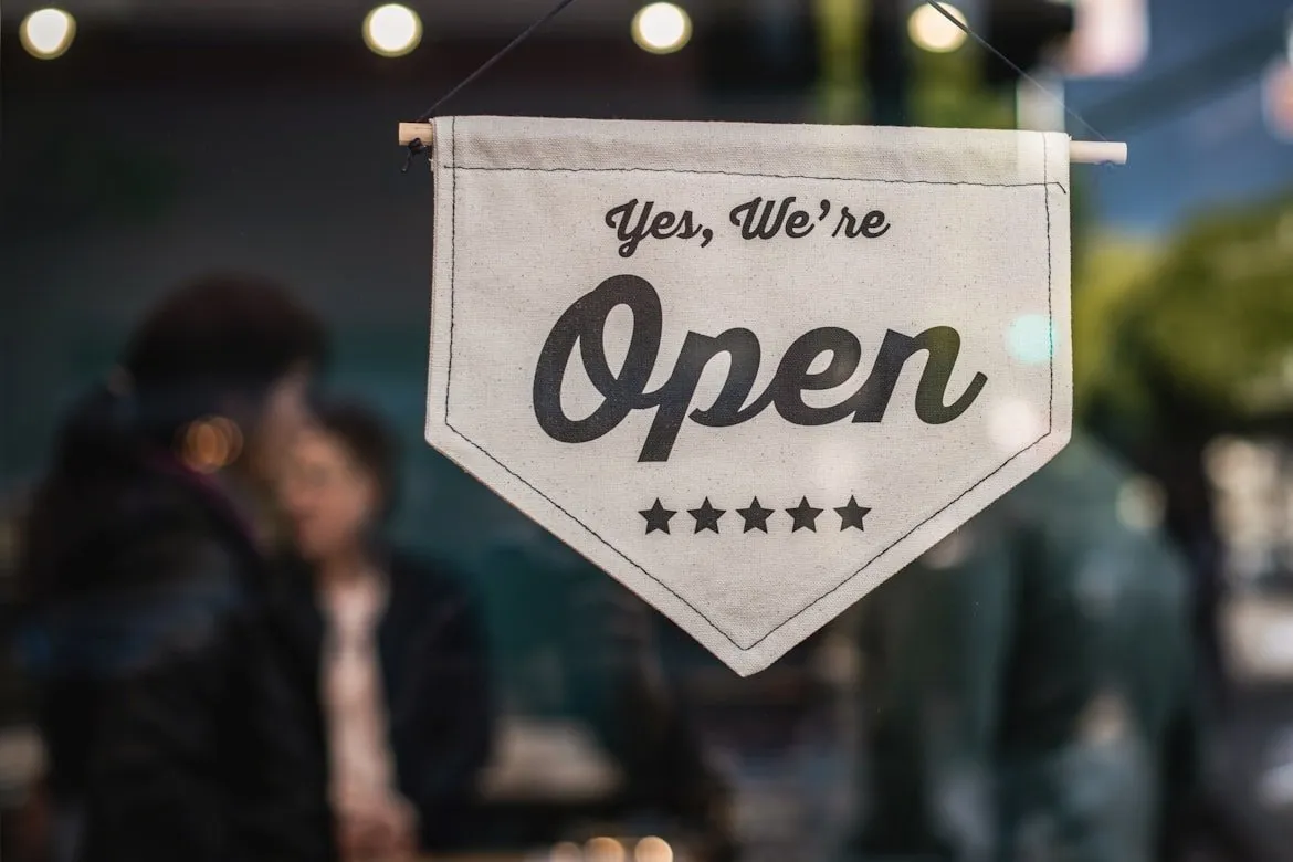 Small business storefront with open sign displaying entrepreneurship and business formation